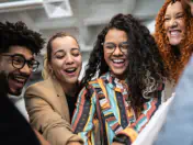 Smiling people gather in an office