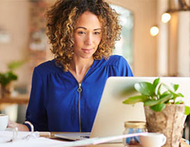 Small business owner looking at laptop screen