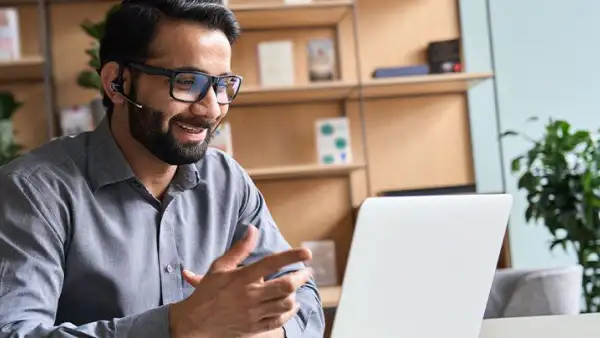 Guy looking with a mona lisa smile at his computer